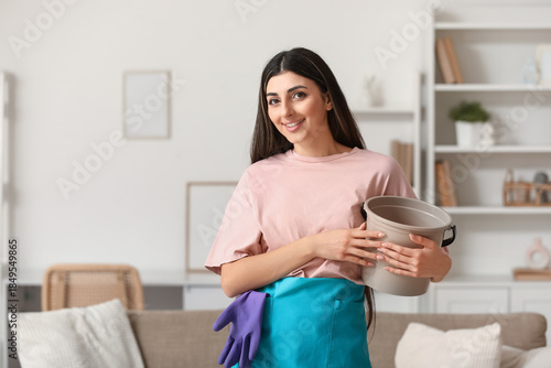 Smiling young woman holding...