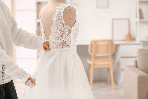 Female tailor sewing weddin...