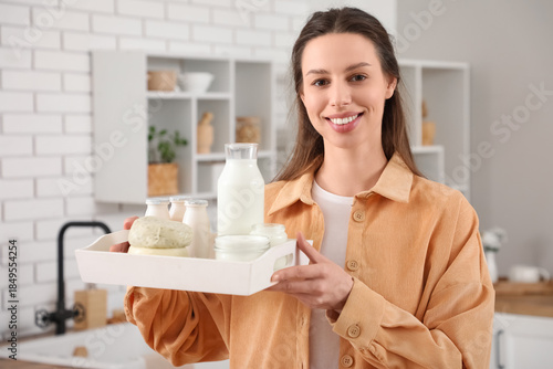 Young woman holding tray wi...
