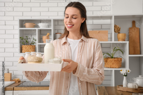 Young woman holding tray wi...