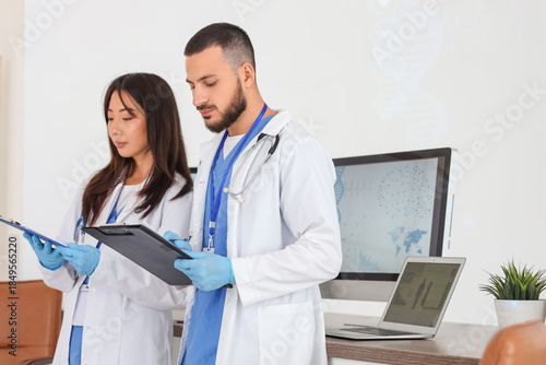 Young doctors with clipboar...