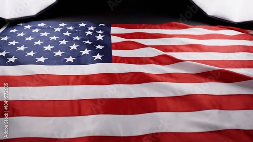 Wavy textile of a national flag with red and white stripes and blue field with white stars