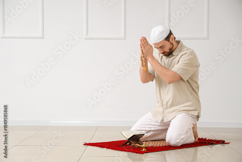 Young Muslim man with Koran...