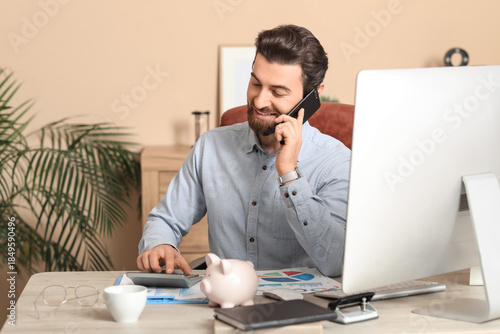 Young businessman with calc...