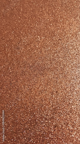 Rose gold glitter texture background with dense sparkle and luxury metallic shine
