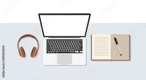 Laptop headphones and notebook with pen on a desk.