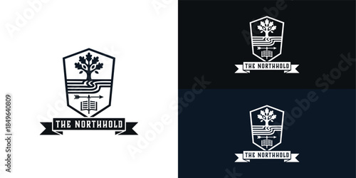 The modern black shield crest features a sturdy tree, winding paths, and an arrow positioned above an open book. This design successfully blends a bold, simplistic aesthetic with heritage.