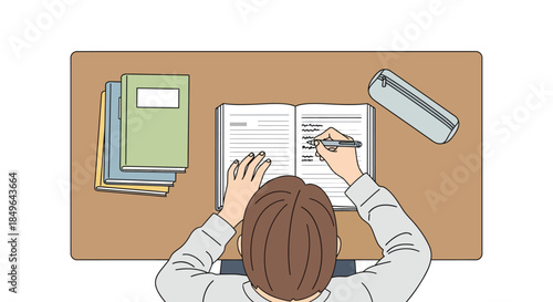 Student diligently writing in notebook at desk with books.