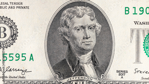 A detailed close-up image of multiple two-dollar bills featuring the portrait of Thomas Jefferson, arranged in an overlapping manner. Two american dollars banknote close up.