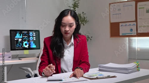 Businesswoman calculating financial data and analyzing charts