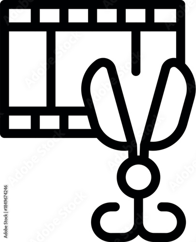 Open scissors cutting a strip of film, symbolizing video editing, post production, and the creative process of filmmaking