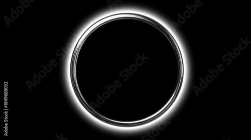 Bright glowing metallic ring with intense halo effect on a deep black background. Abstract silver circle of light.