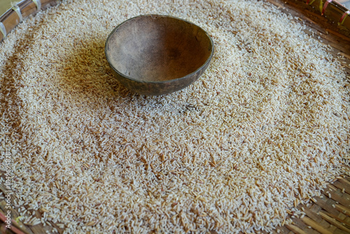 Thai jasmine rice in bamboo basket and on wooden table