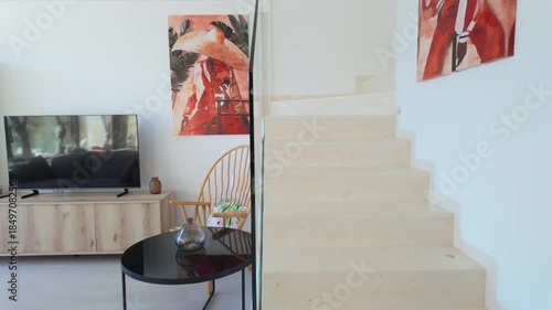Bright villa staircase with cozy lounge and natural light interior design