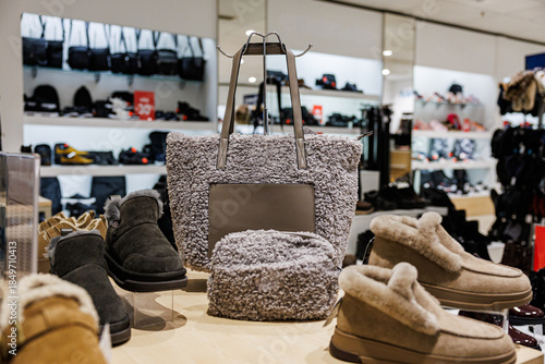 Wallpaper Mural A fuzzy gray tote bag with matching pouch surrounded by warm, fur-lined winter shoes in a retail setting. Cozy, seasonal fashion theme with ample product variety Torontodigital.ca