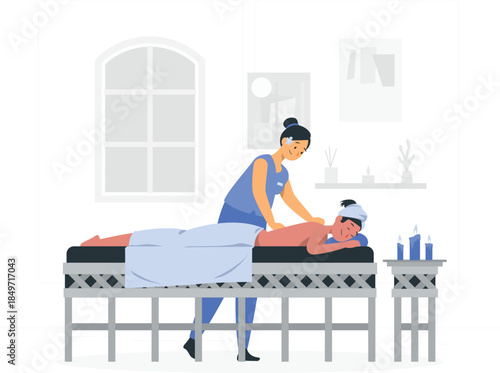 Woman giving man a massage on a table in a spa therapist d