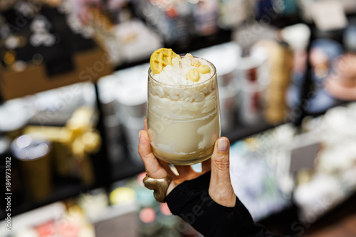 Tableau sur toile A realistic dessert-themed candle in a glass, featuring whipped cream-like wax,
