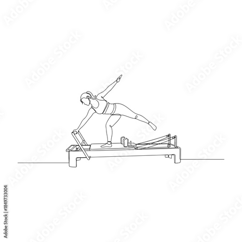 Woman performing pilates exercise on reformer machine.
