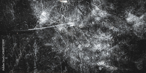 Fotografie Abstract black grunge textured background with white scratches, stains, and dust effects