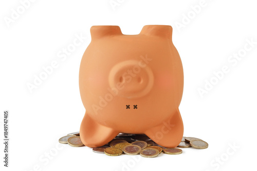 Piggy bank upside down on coins - Concept of savings, spending money and financial crisis