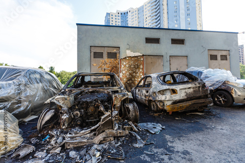 Φωτογραφία Broken and burned cars in the parking lot, accident or deliberate vandalism