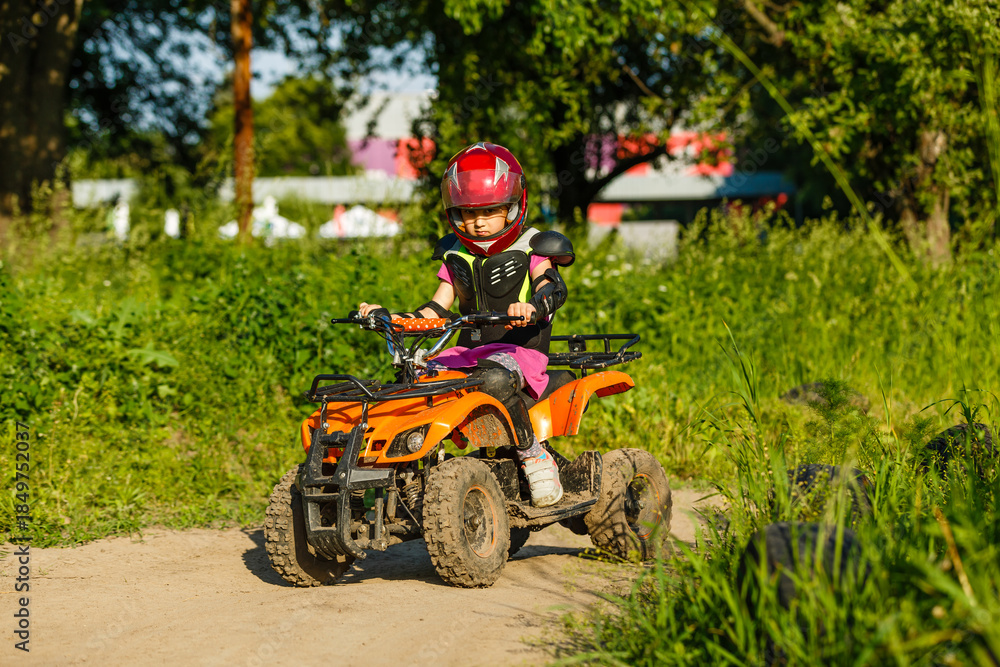 Obraz premium Girl riding an electric quad bike