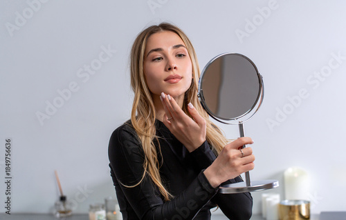 Tableau sur toile Woman focused on skincare, anti-ageing skin care