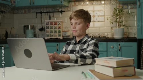 Boy Typing on Laptop at Home