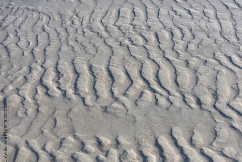 patterns on the sand from the sea waves as a background.