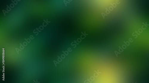 Abstract blurred background of lush green foliage with dappled sunlight filtering through.