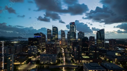 Wallpaper Mural Aerial View of Modern City Skyline with Illuminated Skyscrapers and Dramatic Cloudy Sky During Blue Hour Twilight Torontodigital.ca