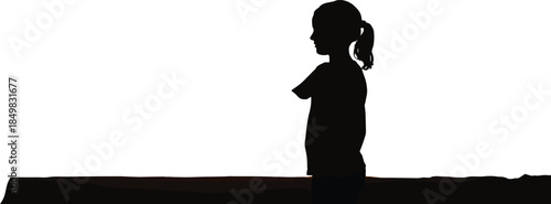 Black silhouette of a young girl with ponytail standing in profile view representing childhood innocence quiet moments and youth development concepts