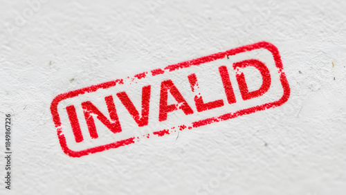 Close-up of red invalid stamp on white background