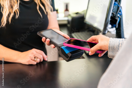 Photography Customer making contactless payment using smartphone at checkout