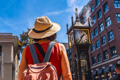 Tourist admiring gastown steam clock in vancouver, british columbia