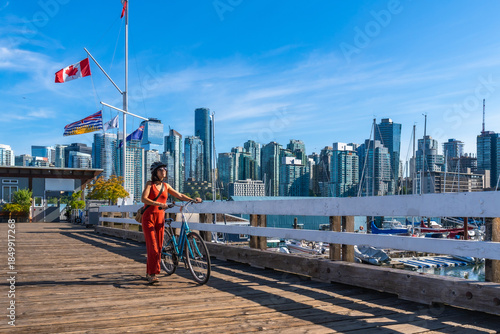 Billede på lærred Tourist walking with bicycle on pier in vancouver, british columbia