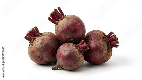 Four freshly harvested earthy red beets with trimmed stems piled together against a clean bright white background ready for cooking or market display