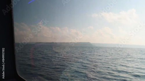 calm ocean view seen through ferry window during daytime travel