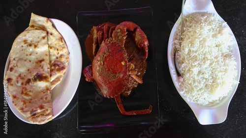indian crab curry meal served with steamed rice and roti top view