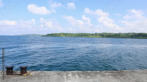 serene seascape observed from harbor pier beneath clear sky