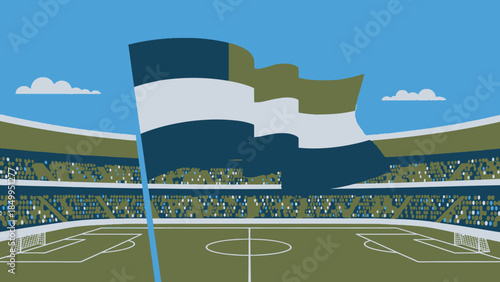 Large national flag (possibly Finland) waving proudly over a soccer stadium on a bright day.