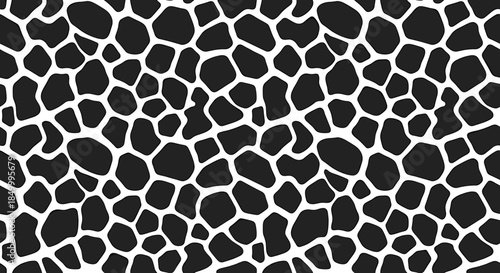 Close-up of a black and white giraffe print pattern on a flat surface with a shallow depth of field and a neutral mood against a clean white background.