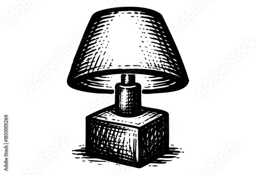 A black and white illustration of a vintage desk lamp with a conical shade and a cubic base, rendered in a classic woodcut style against a clean white background.