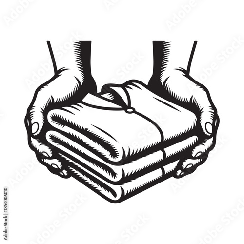 Hands gently holding a neatly folded stack of clothing items