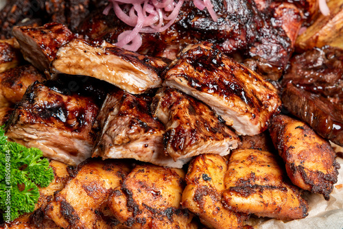 Photos A close-up shot of a hearty mixed barbecue platter featuring glazed pork ribs, c