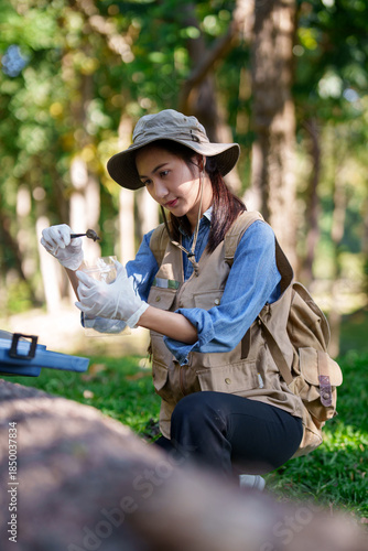 Asian Woman Botanist Researcher Collecting Soil Samples for Environmental Study in Nature Park Conducting Ecological Analysis Outdoors
