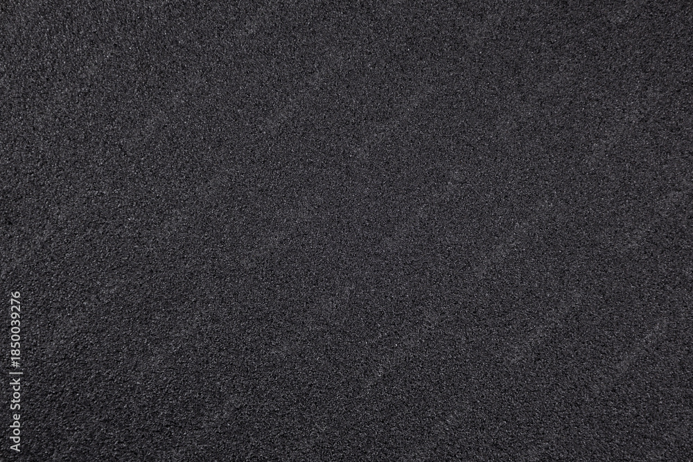 Fototapeta premium Surface of dark material with fine texture used for various applications in construction or art in a studio or workshop setting