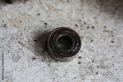 Plakat w ramie Old rusty metal ball bearing on dirty background mechanical engine part replacement