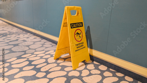 Yellow Caution Tripping Hazard Sign on Carpet