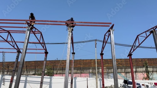 Workers shuttering on top of building